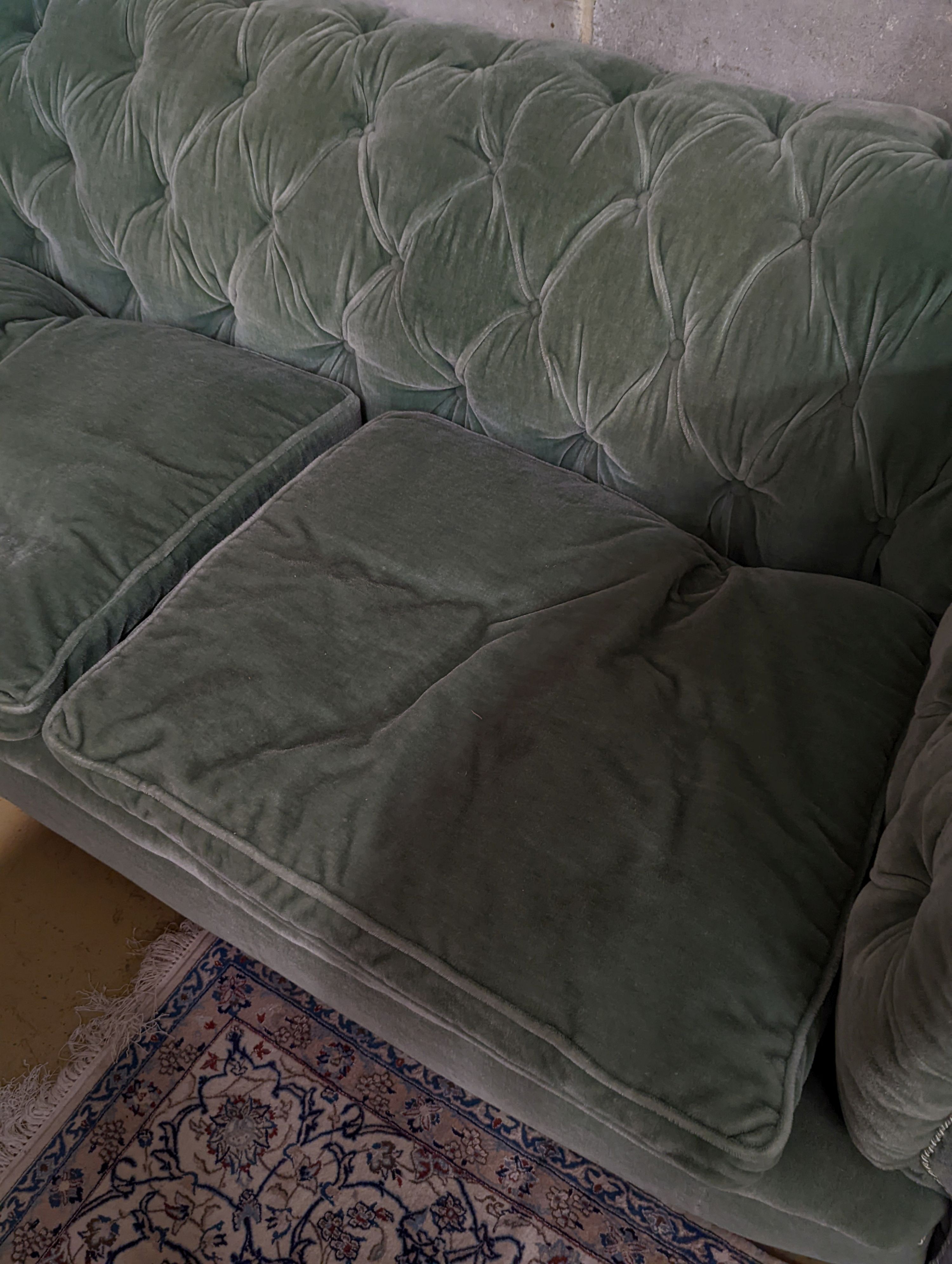 A late Victorian Chesterfield settee upholstered in buttoned green fabric, length 194cm, depth 80cm, height 76cm